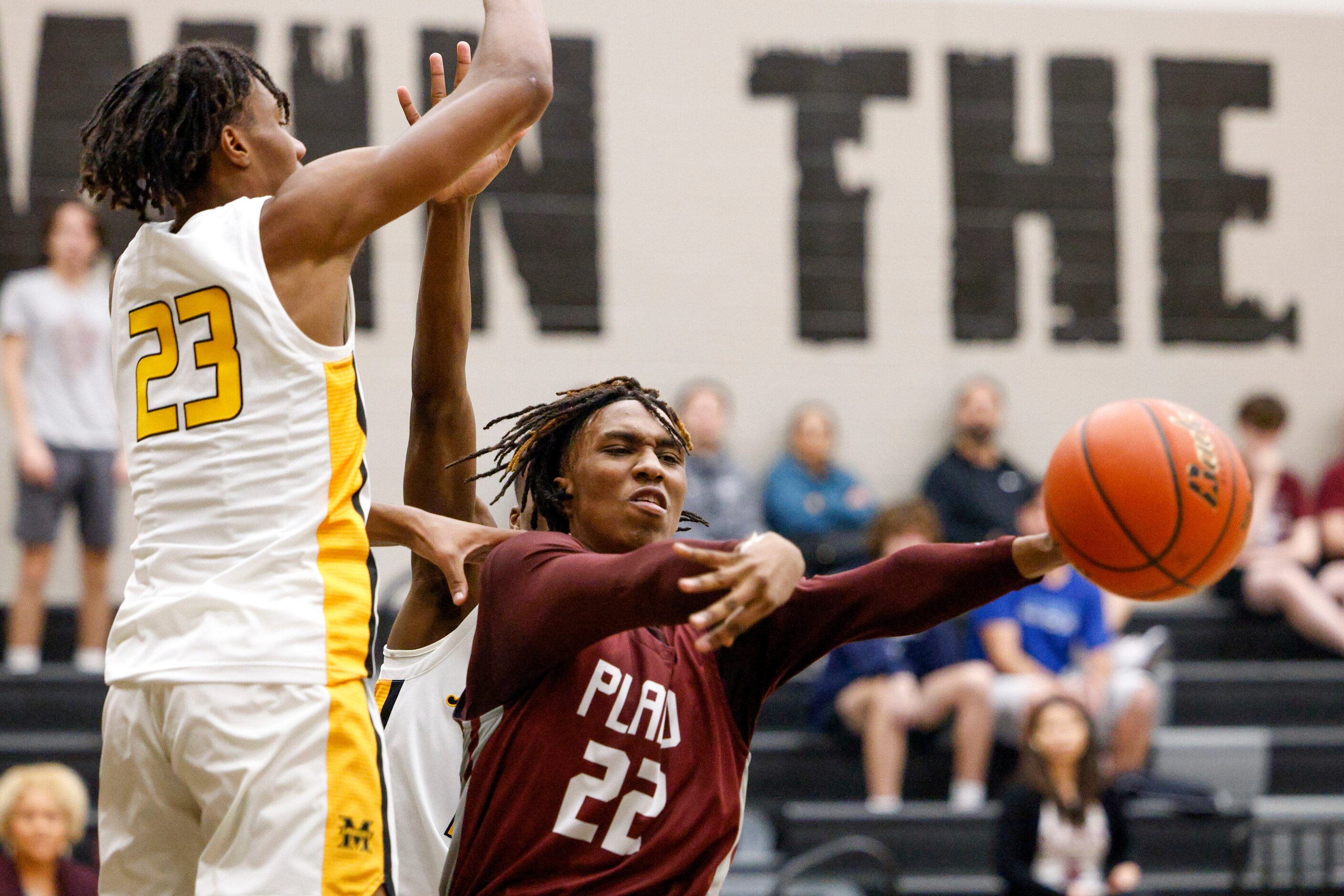 Plano forward Nikk Williams (22) passes the ball around Frisco memorial forward Leon Horner...