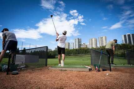 Dallas Stars player Tyler Seguin (middle) tees off on a driving range on Sept. 9, 2020...