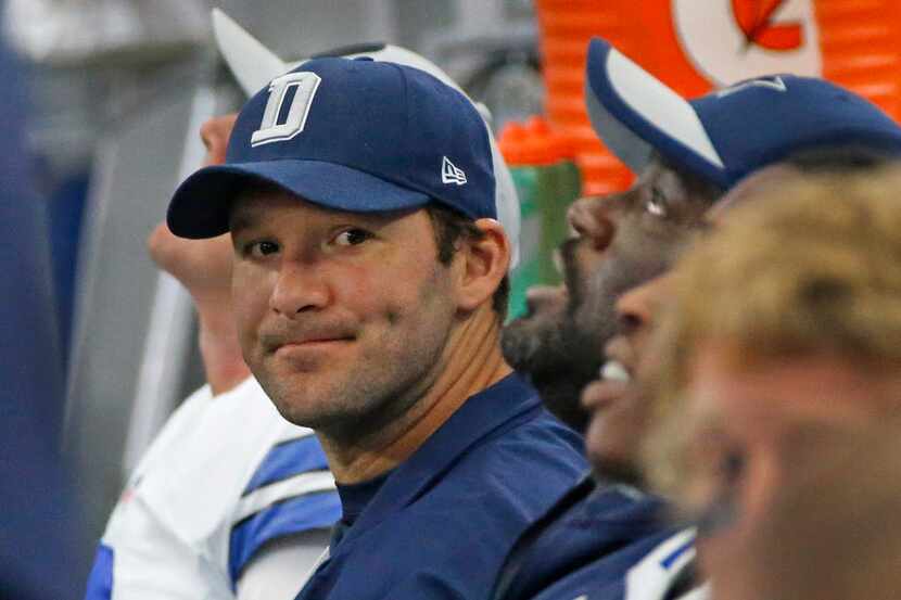 Injured Cowboys quarterback Tony Romo (9) is pictured on the sidelines as the clock winds...