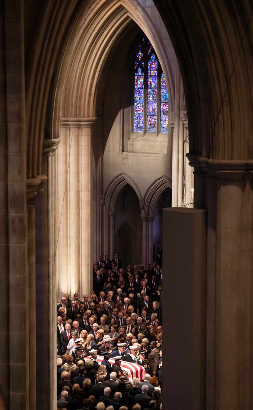 A military honor guard carried the flag-draped casket into the Washington National Cathedral...