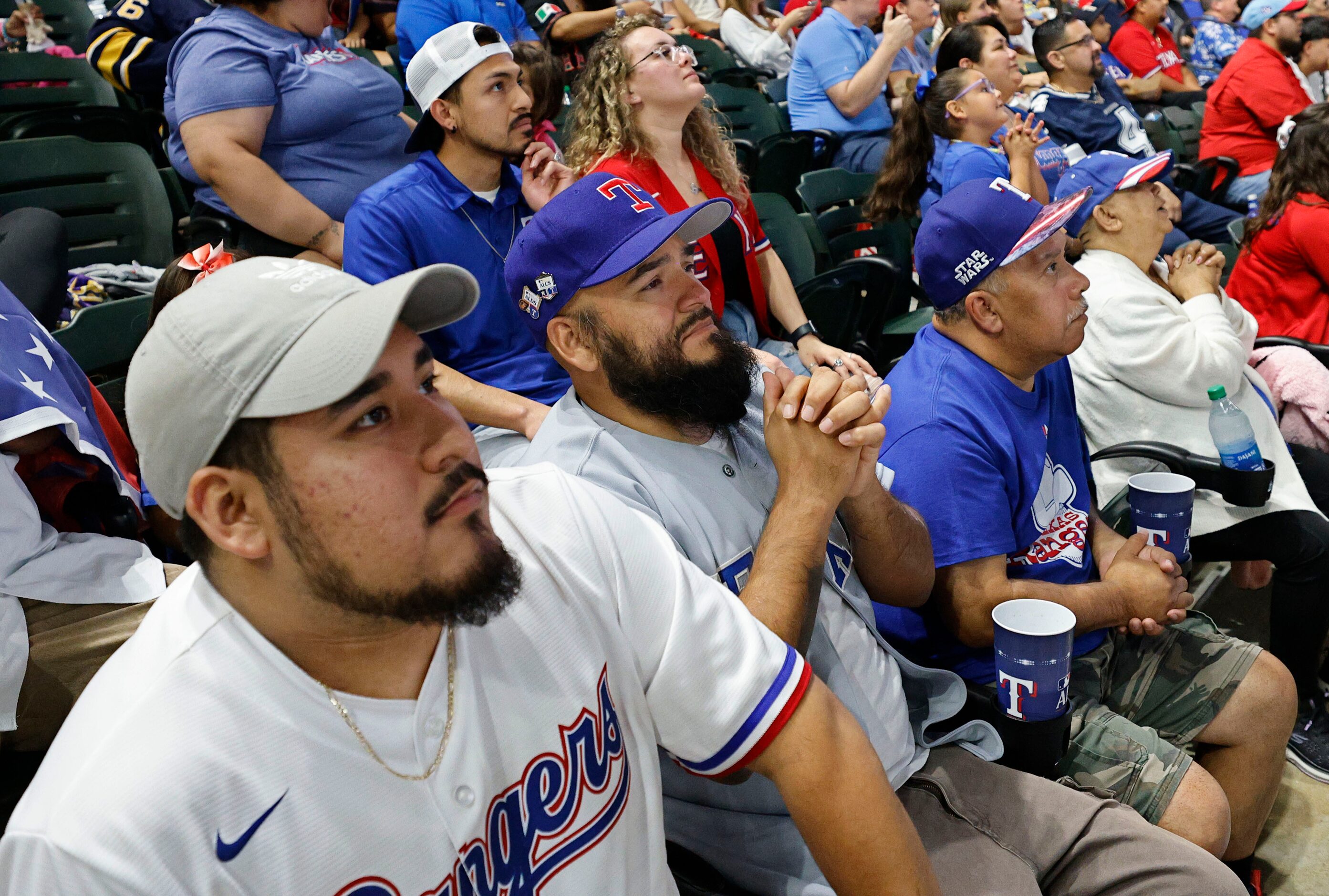 Texas Rangers fans Diego Rodriguez, left, and John Sanchez, second from left, both from...