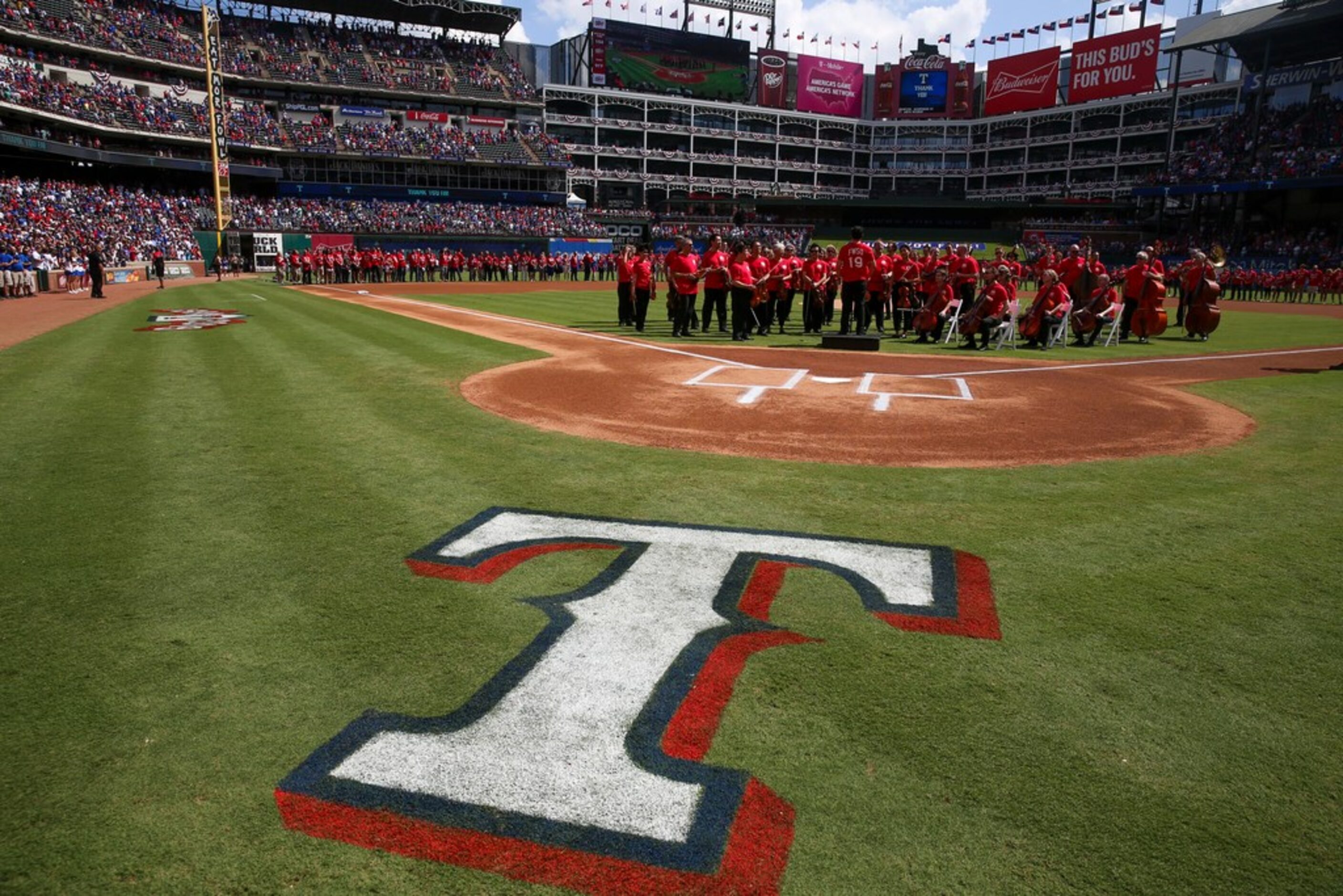 The Forth Worth Symphony Orchestra prepare to perform the National Anthem before a the...