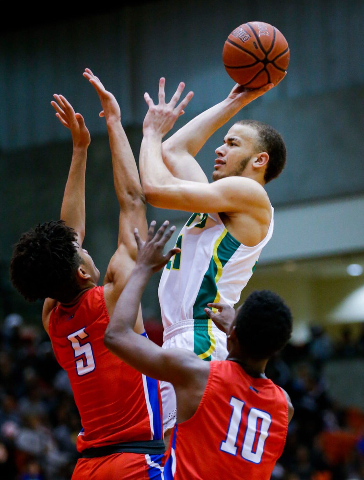 DeSoto sophomore forward Duncan Powell attempts a shot as Duncanville junior guard Micah...