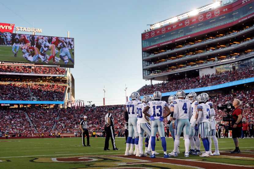 Dallas Cowboys quarterback Dak Prescott (4) huddles the offense in the end zone during a...
