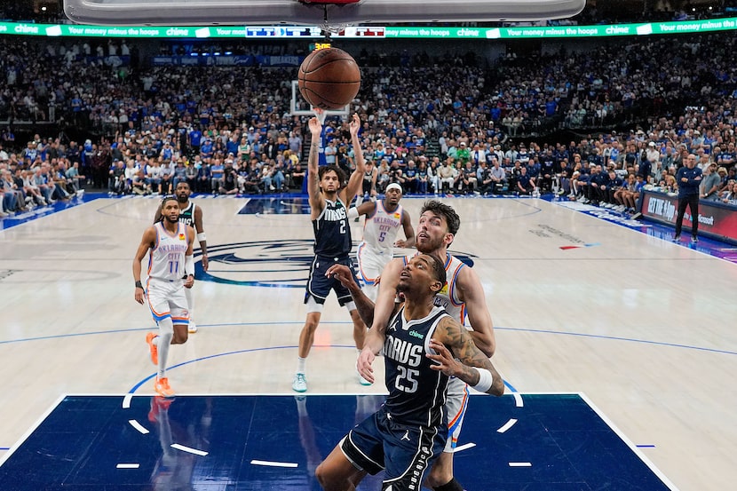 Dallas Mavericks forward P.J. Washington (25) boxes out Oklahoma City Thunder forward Chet...