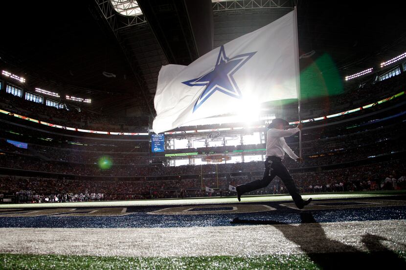 The Dallas Cowboys Flag Squad runs after a touchdown during a game between the Dallas...