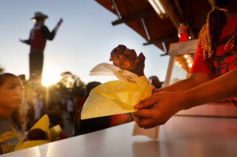 People step up to buy turkey legs in Big Tex Circle during the State Fair of Texas at Fair...