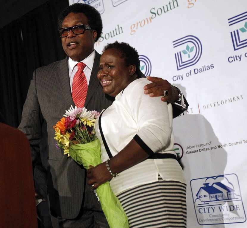 Dwaine Caraway presented a bouquet of flowers to Carolyn Davis at the new Lancaster Urban...