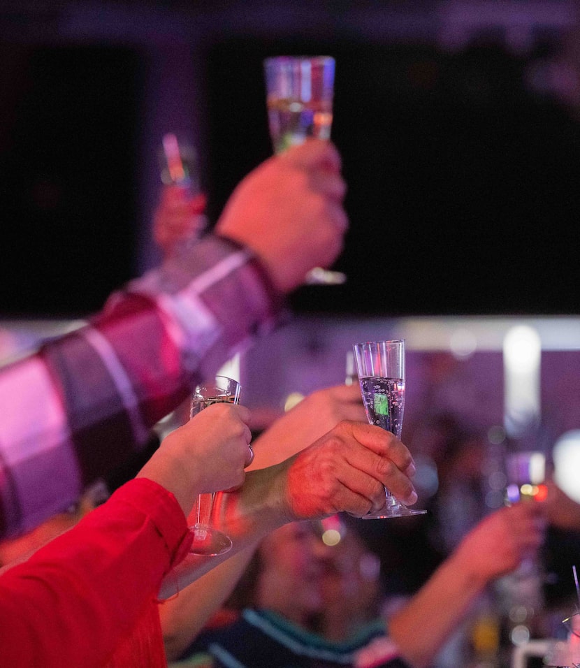 People toast after Panther City BBQ was marked ‘Recommended’ while watching the live cast...