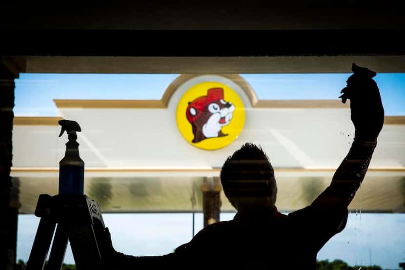 Sean Mizell washes  windows for the opening of the Buc-ee’s in Terrell — the better to gaze...