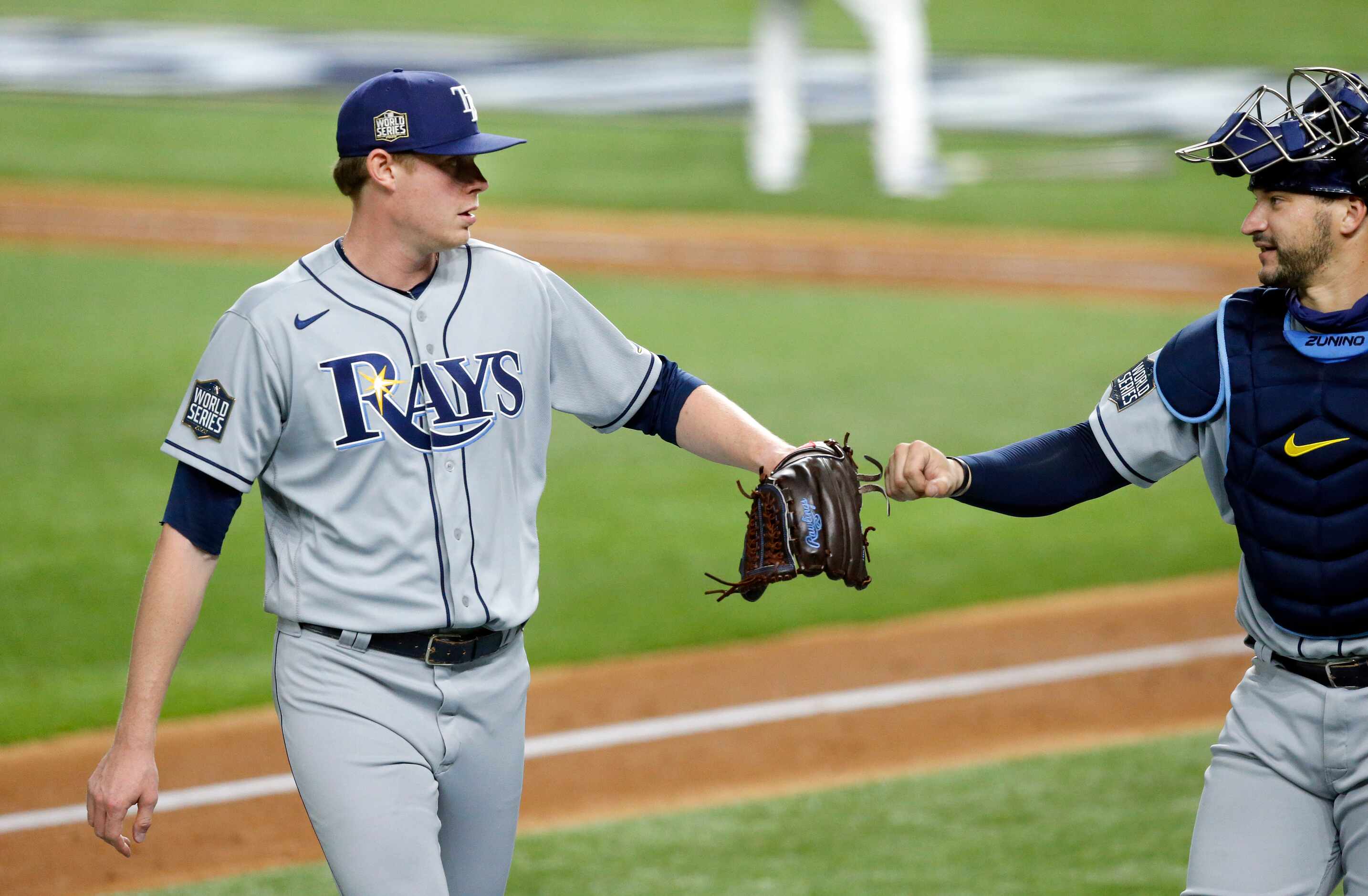 Tampa Bay Rays relief pitcher Peter Fairbanks (29) receives a fist bump from catcher Mike...