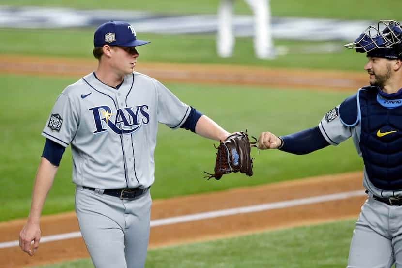 Tampa Bay Rays relief pitcher Peter Fairbanks (29) receives a fist bump from catcher Mike...