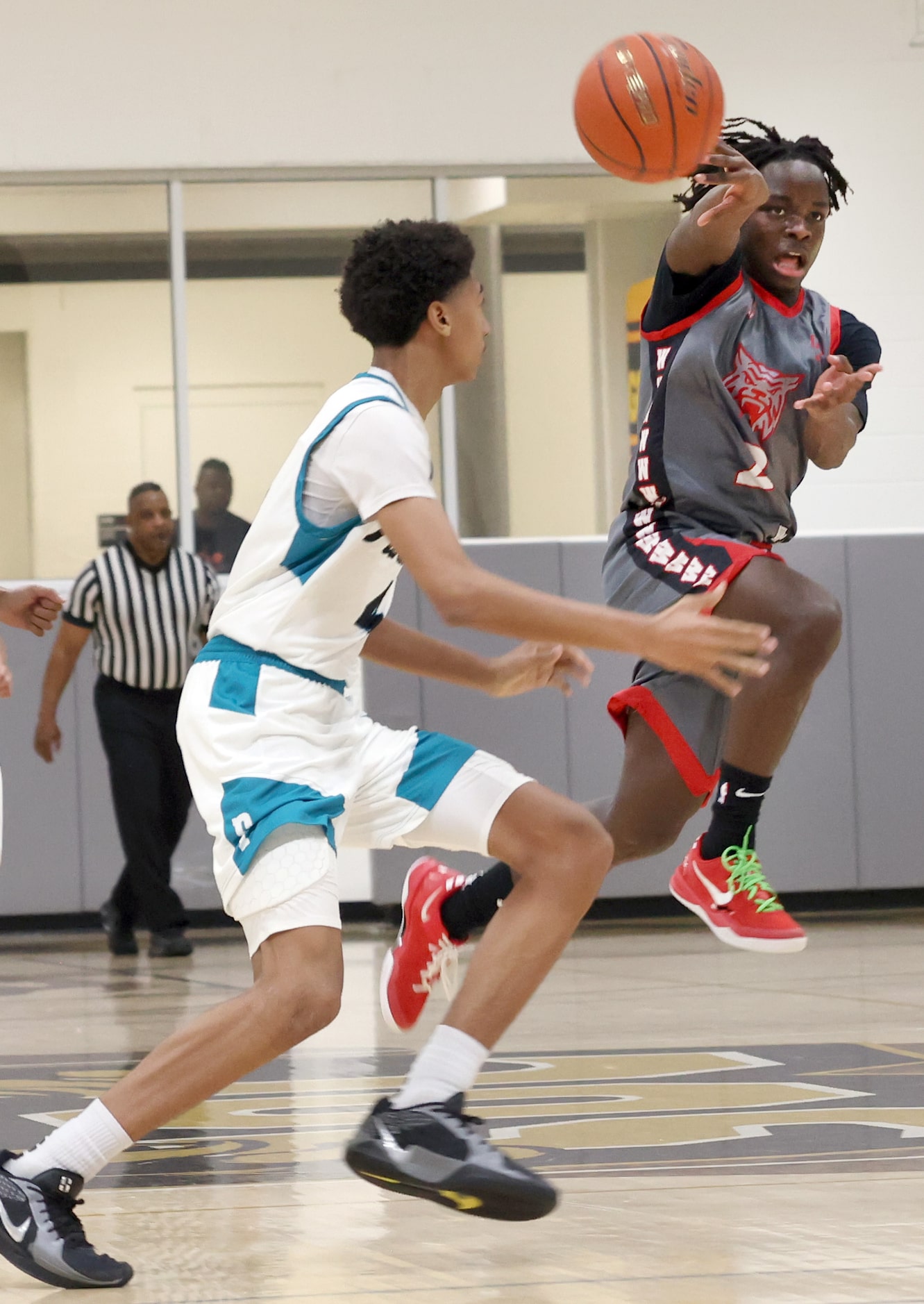 Dallas Woodrow Wilson's Isaac Lwiate (2), right, launches a jump pass, after a steal, to a...