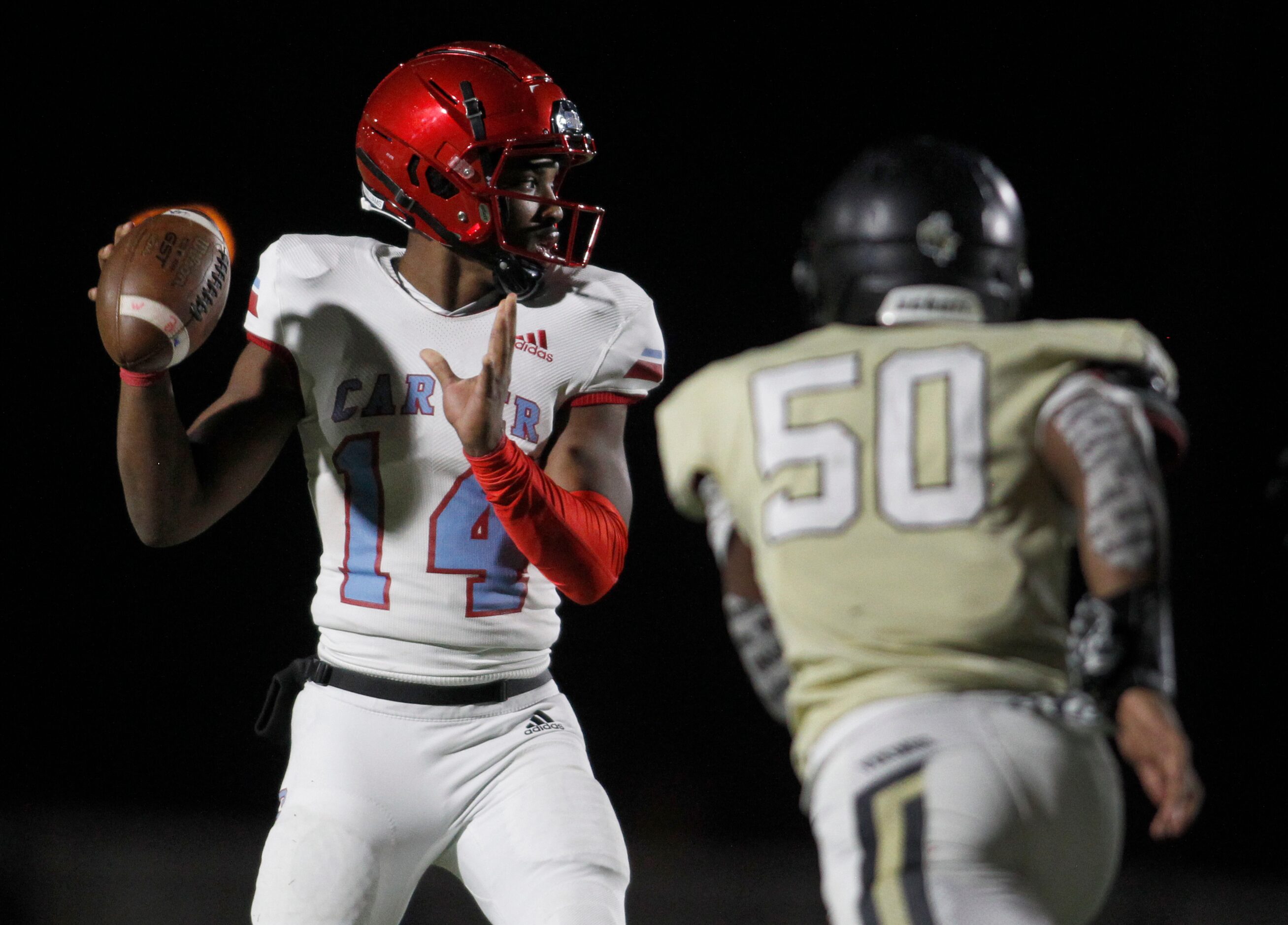 Dallas Carter quarterback J'Dyn Williams (14) sets to pass as Dallas Pinkston defensive...