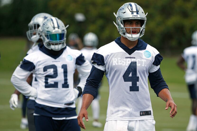 Dallas Cowboys quarterback Dak Prescott (4) and running back Ezekiel Elliott (21) prepare to...