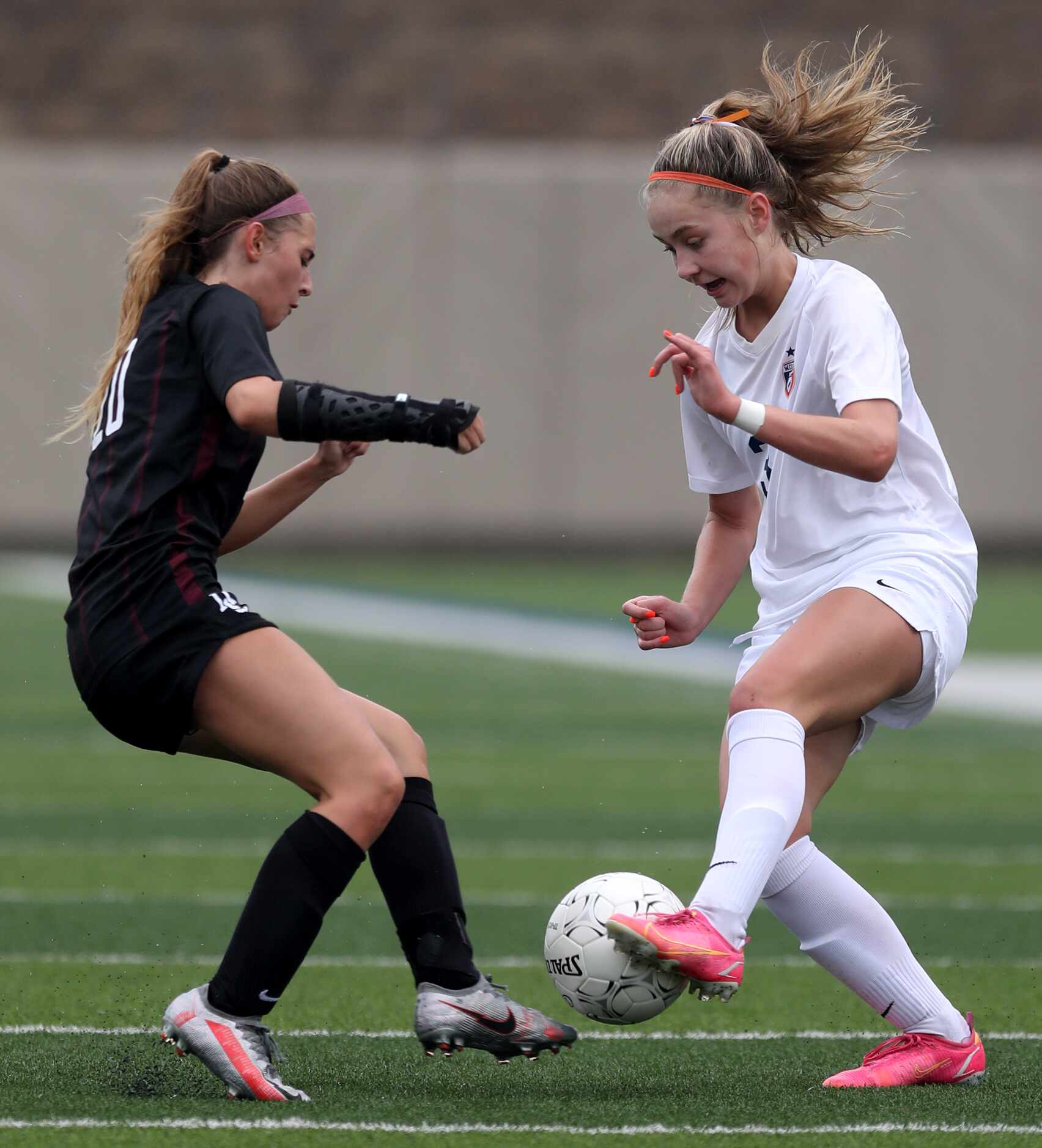 Dripping Springs' Kaleigh Howell (20) and Wakeland's Bella James (3) struggle for control of...