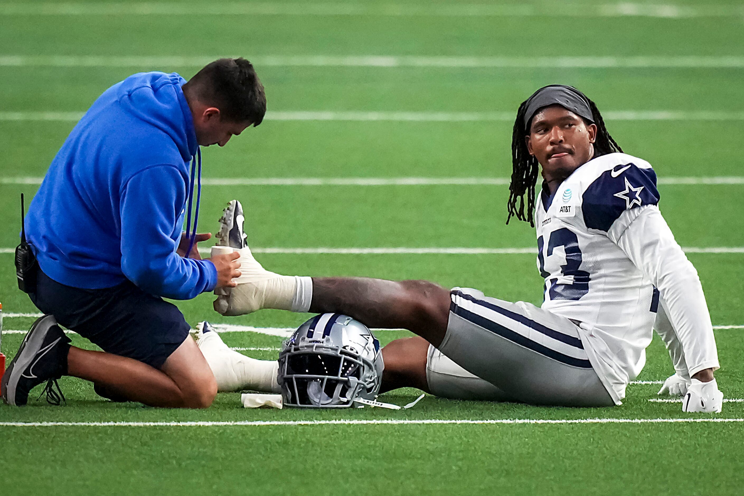 Dallas Cowboys running back Rico Dowdle (23) gets his ankle taped during a training camp...