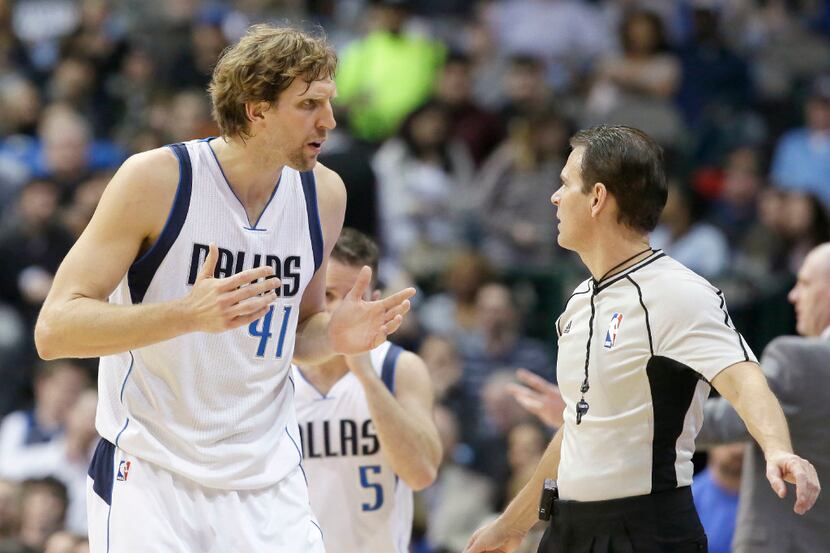 Dallas Mavericks forward Dirk Nowitzki questions a call by referee Mark Ayotte during the...