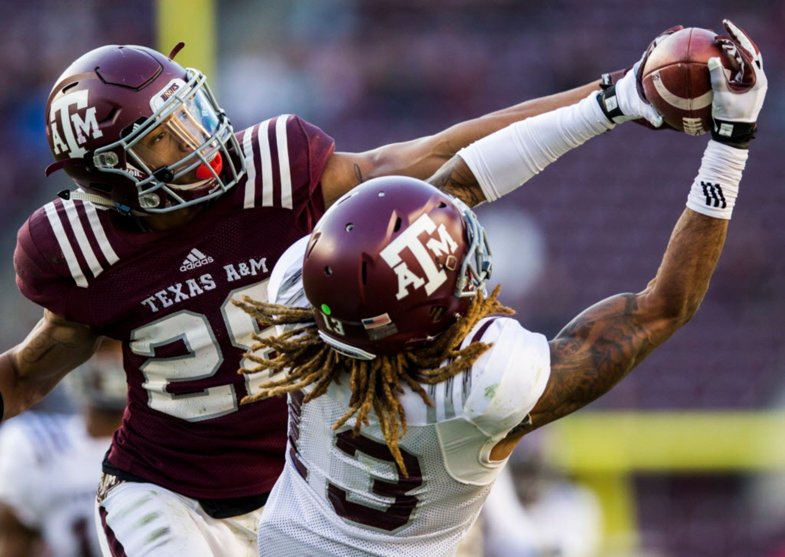 Texas A&M's Kendrick Rogers, top, is tackled by Clemson's Derion