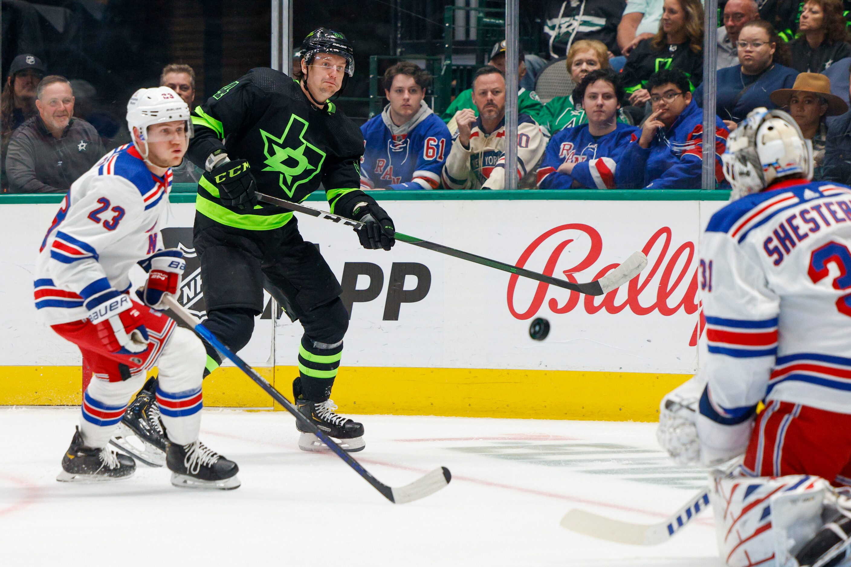 Dallas Stars right wing Denis Gurianov (34) shoots the puck alongside New York Rangers...