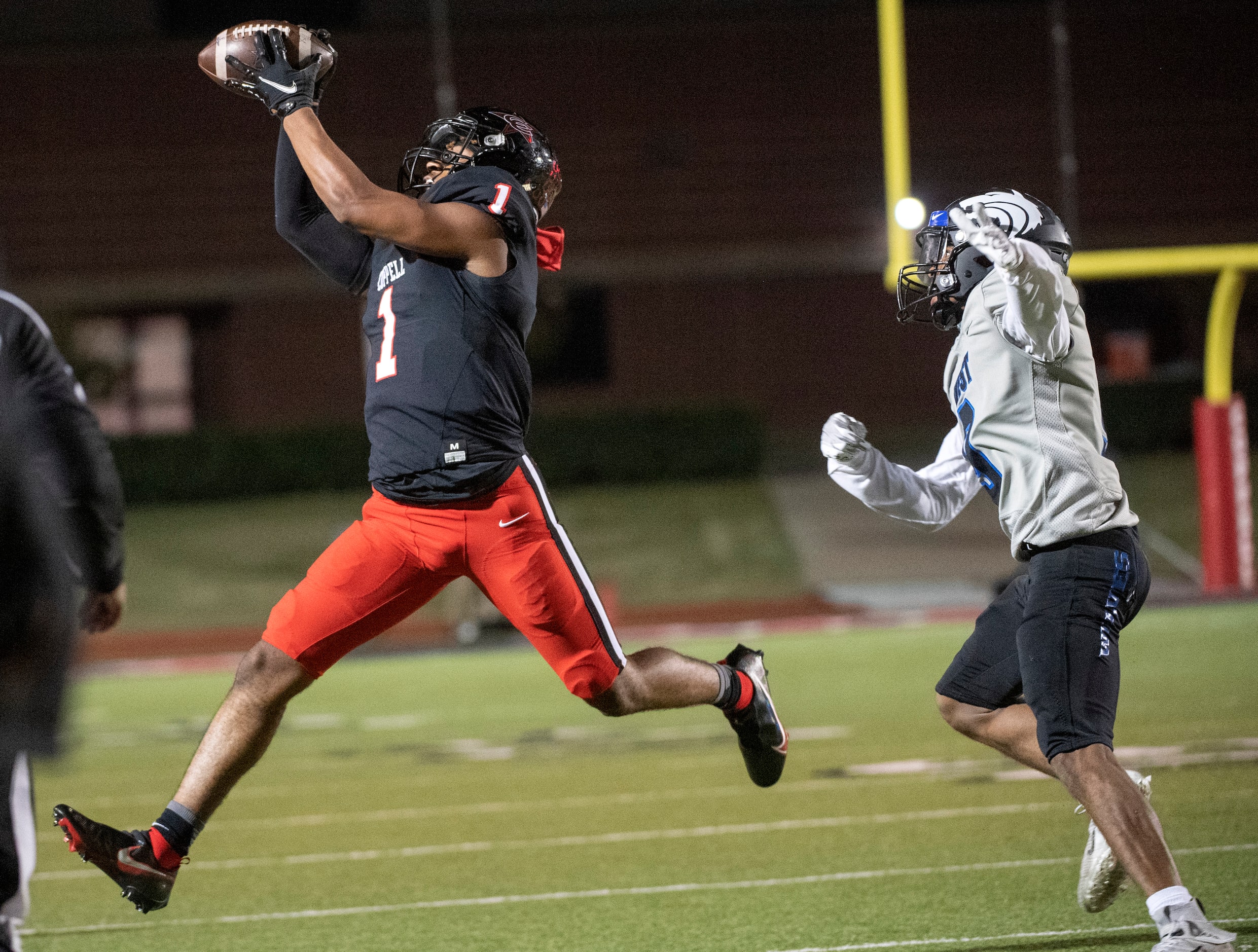 Coppell senior wide receiver Brayden Ardis (1) makes a catch in front of Plano West senior...