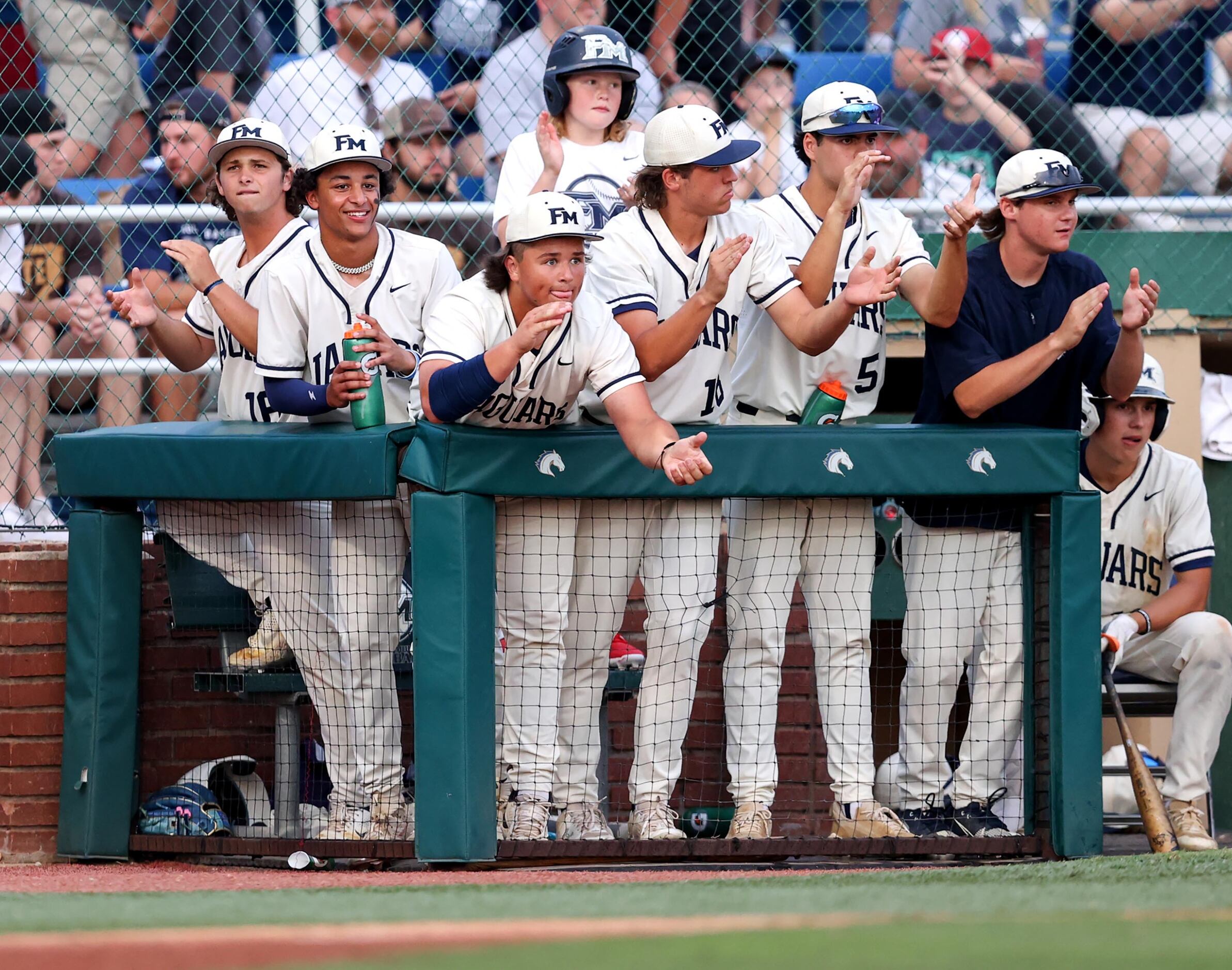 The Flower Mound bench cheer on their team against Denton Guyer during Game 1 of a best-of-3...