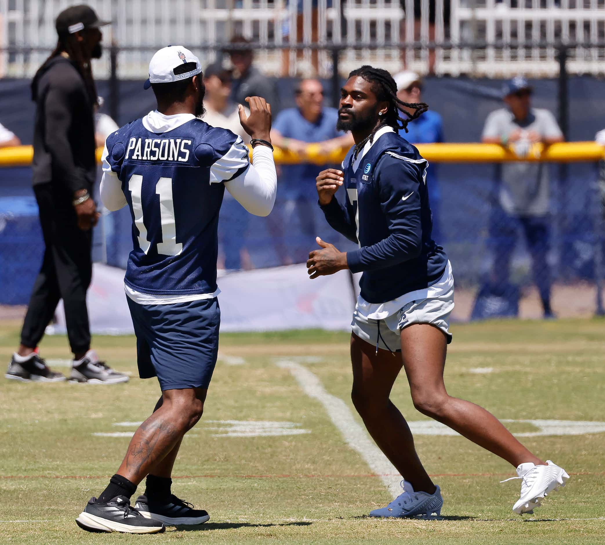 Dallas Cowboys cornerback Trevon Diggs (7) and linebacker Micah Parsons (11) playfully spar...