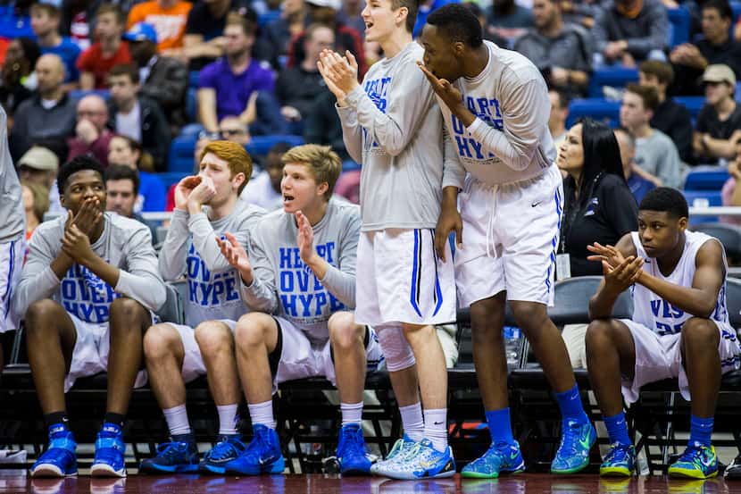 Plano West celebrates a point during their UIL Class 6A state semifinal boys basketball game...