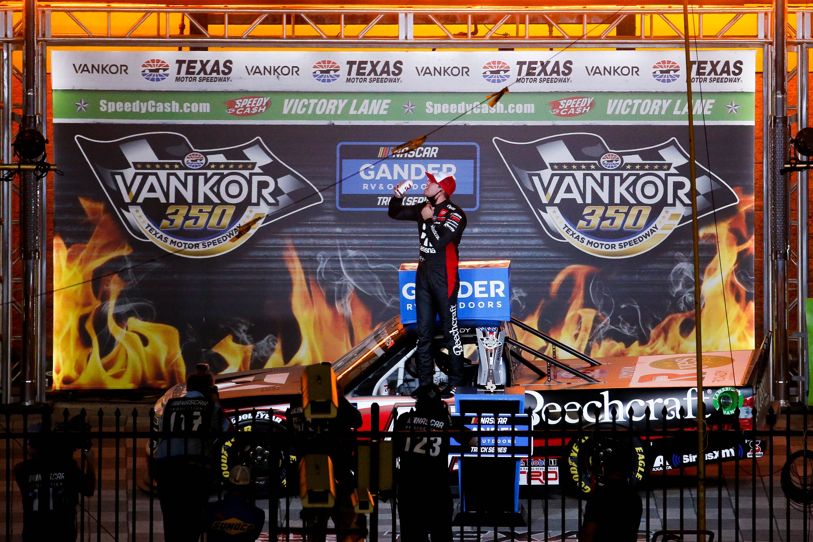 Driver Kyle Busch (No. 51)celebrates in Victory Lane after winning the Vankor 350 NASCAR...