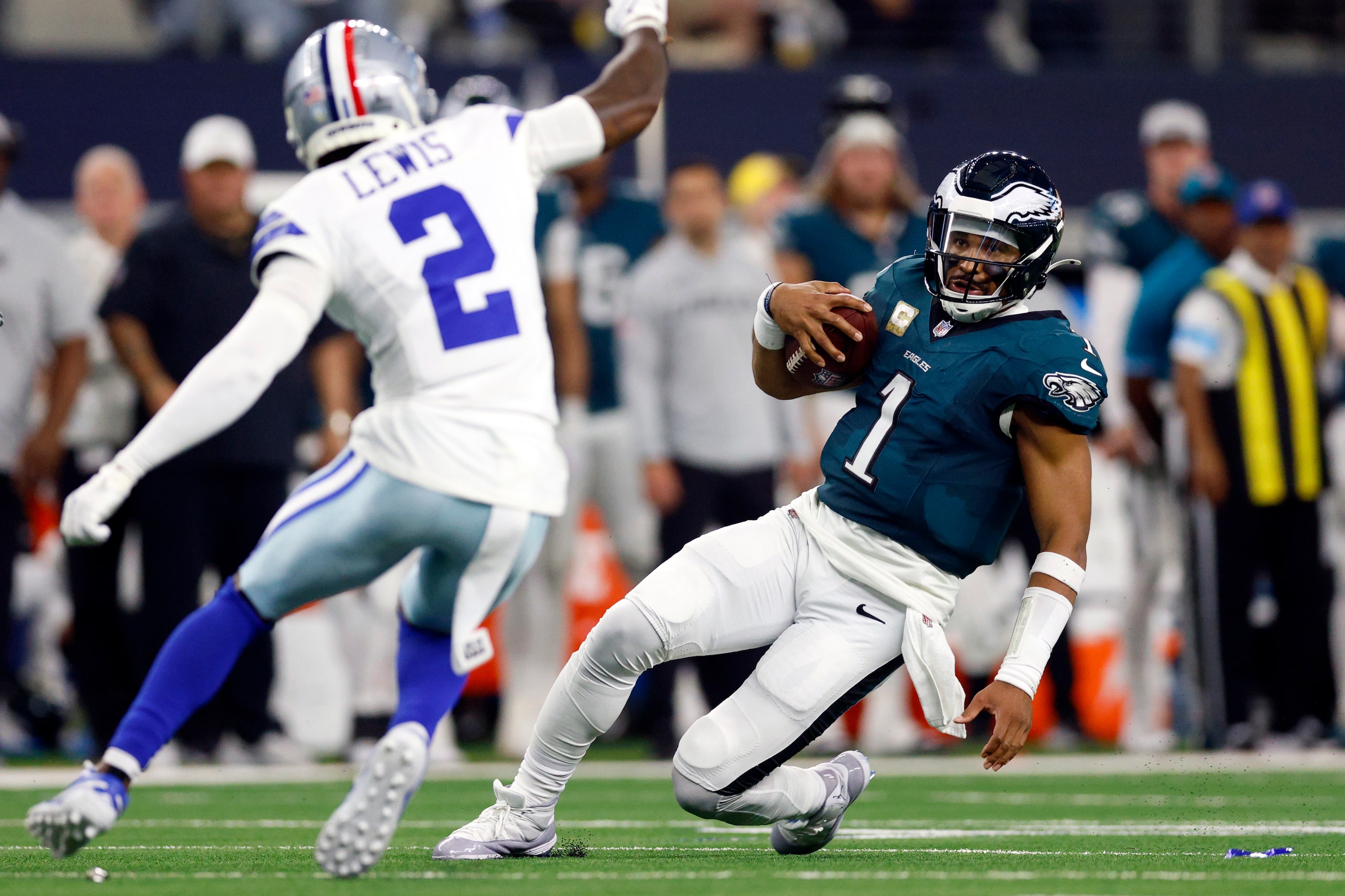 Philadelphia Eagles quarterback Jalen Hurts (1) slides for a first down in front of Dallas...