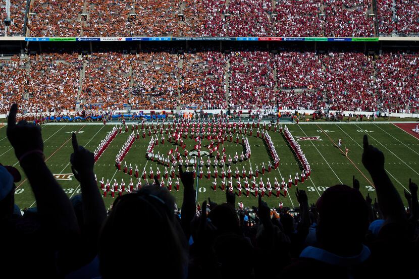 Oklahoma Sooners fans cheer while the band performs before the AT&T Red River Showdown...