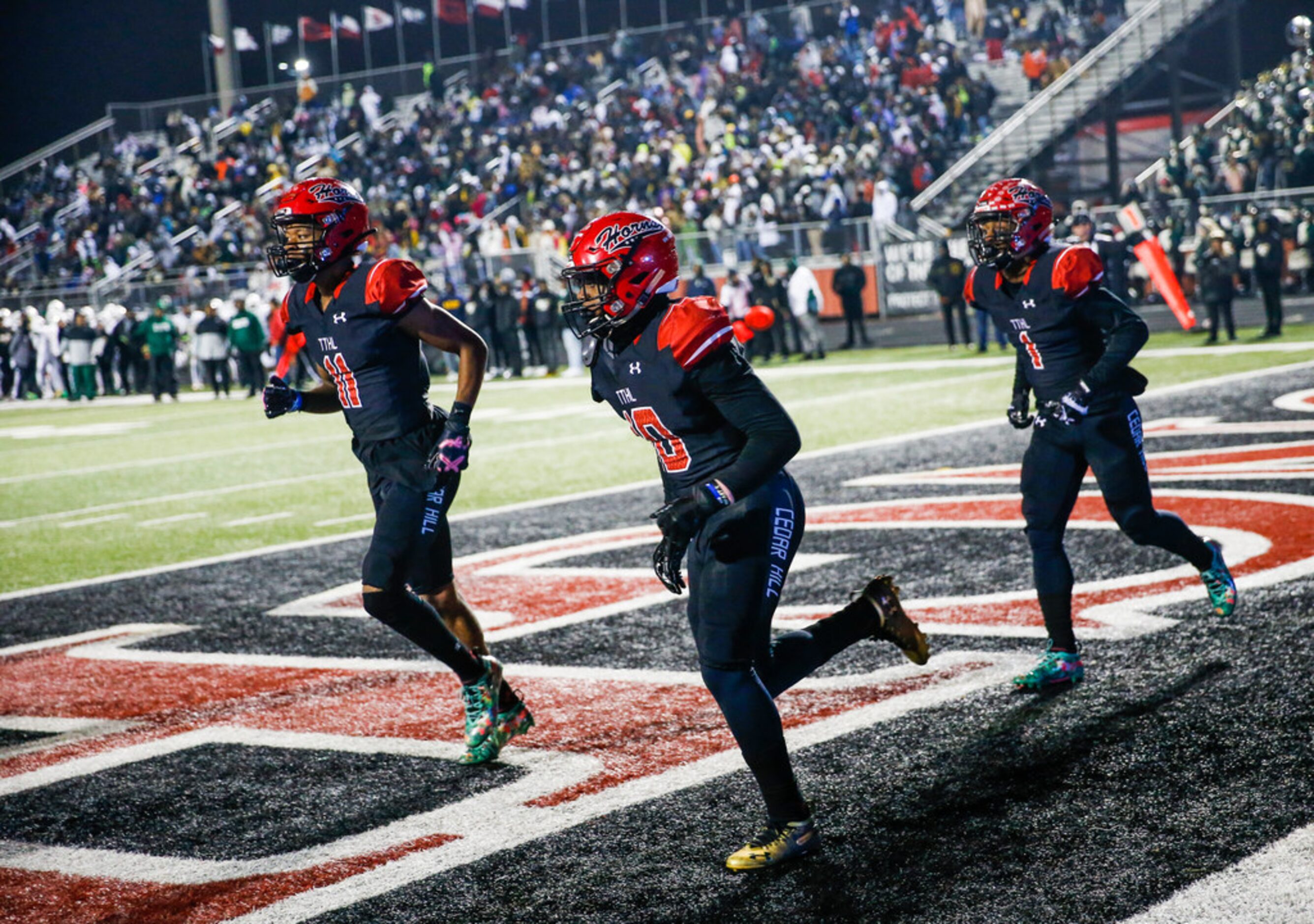 The Cedar Hill longhorns celebrate a touchdown during a high school football match up...