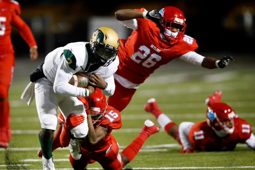 DeSoto quarterback Shun'Darion Ward (2) is dragged down from behind by Skyline defensive...