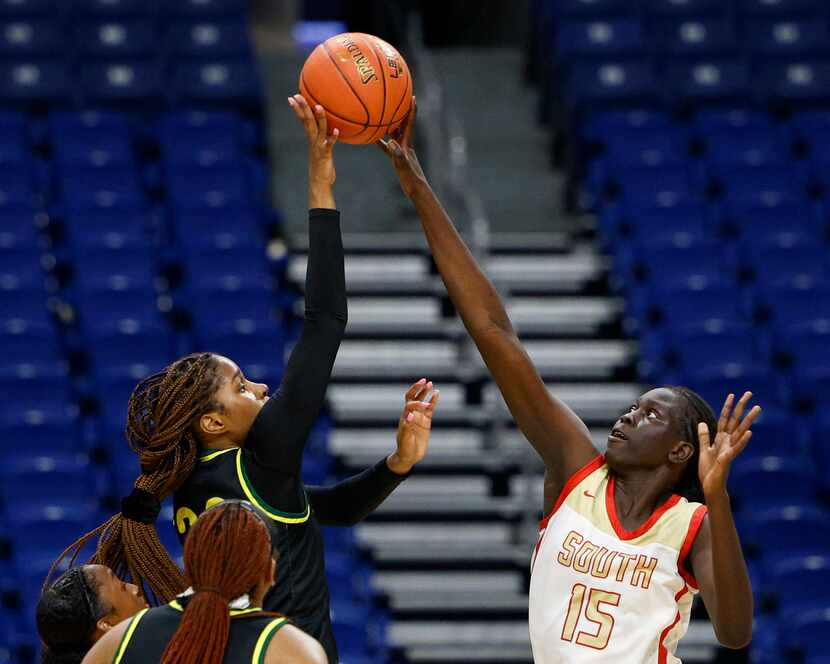 South Grand Prairie center Adhel Tac (15) blocks the shot of DeSoto guard Ayanna Thompson...