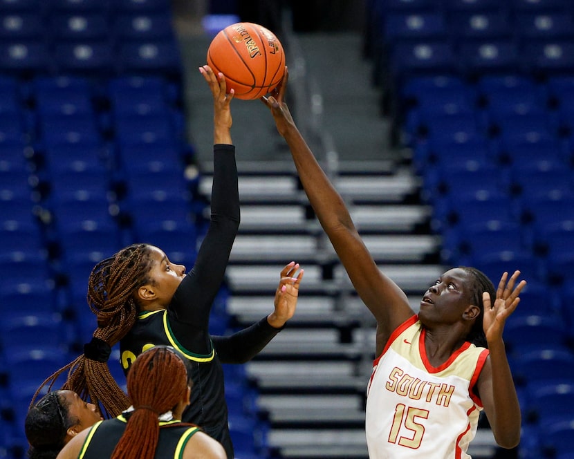 South Grand Prairie center Adhel Tac (15) blocks the shot of DeSoto guard Ayanna Thompson...