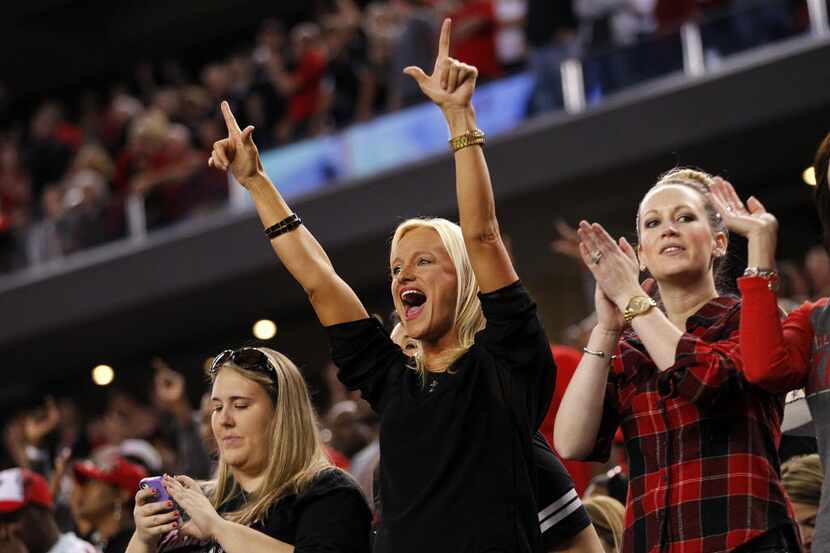 Texas Tech fans give the guns up after their second first quarter touchdown against the...