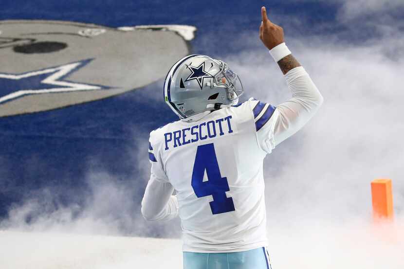 Dallas Cowboys quarterback Dak Prescott (4) points up as he takes the field during...