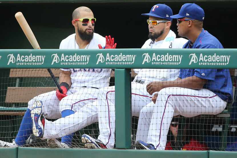 Texas Rangers second baseman Rougned Odor (12) talks with Robinson Chirinos and Adrian...