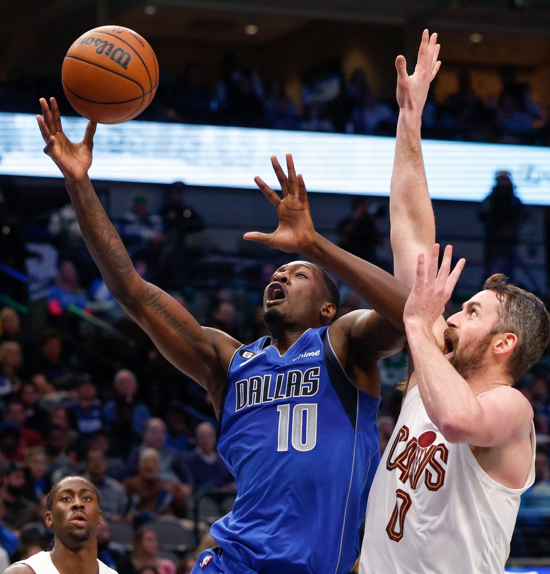 Dallas Mavericks forward Dorian Finney-Smith (10) attempts a layup against a defending...