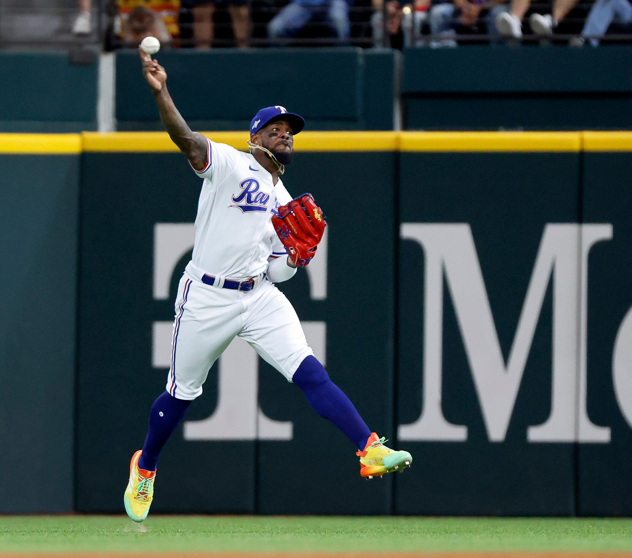 Texas Rangers right fielder Adolis Garcia (53) throws the ball back in after catching a line...