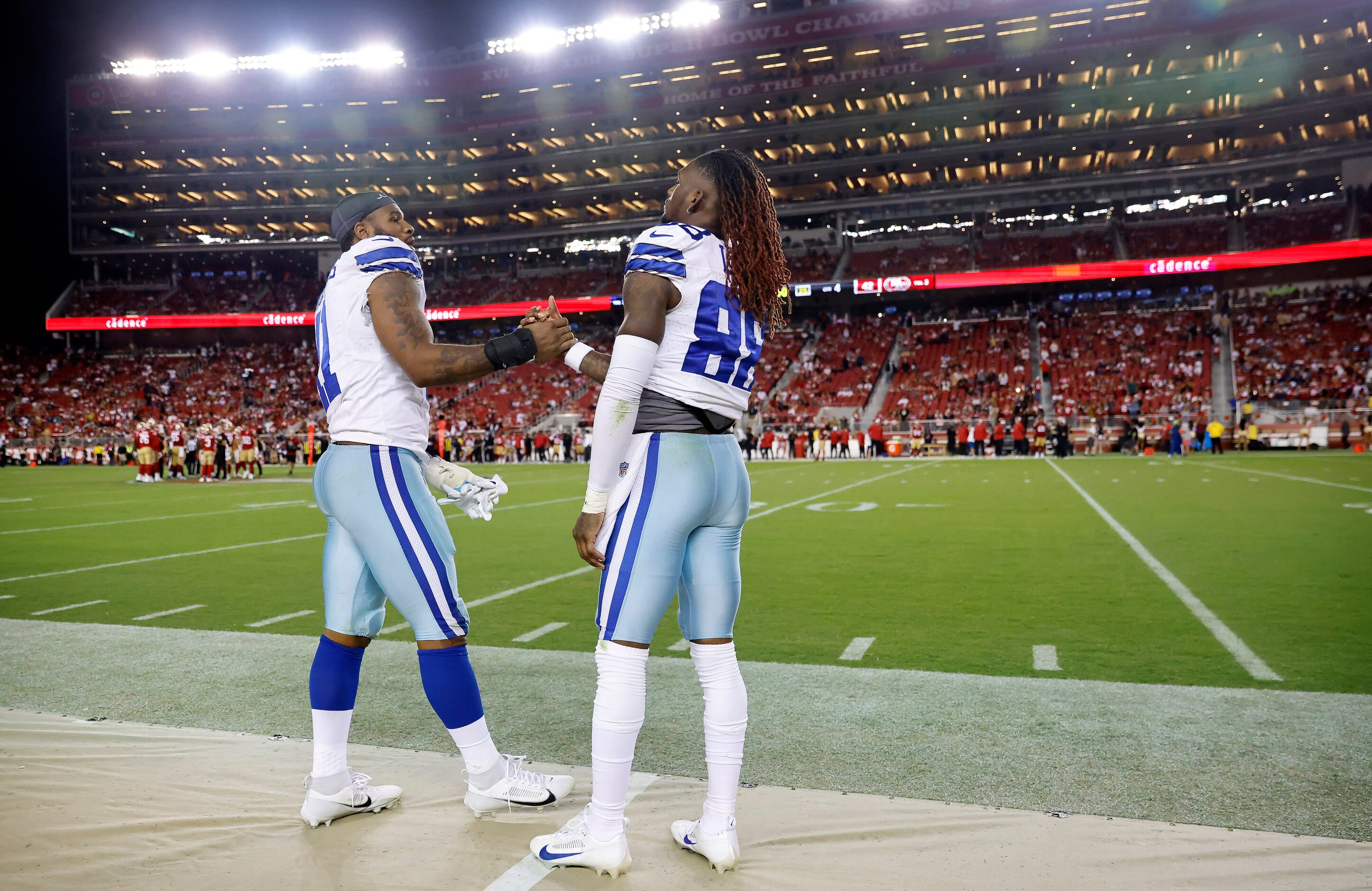 Dallas Cowboys linebacker Micah Parsons (11) shakes hands with teammate CeeDee Lamb (88) as...