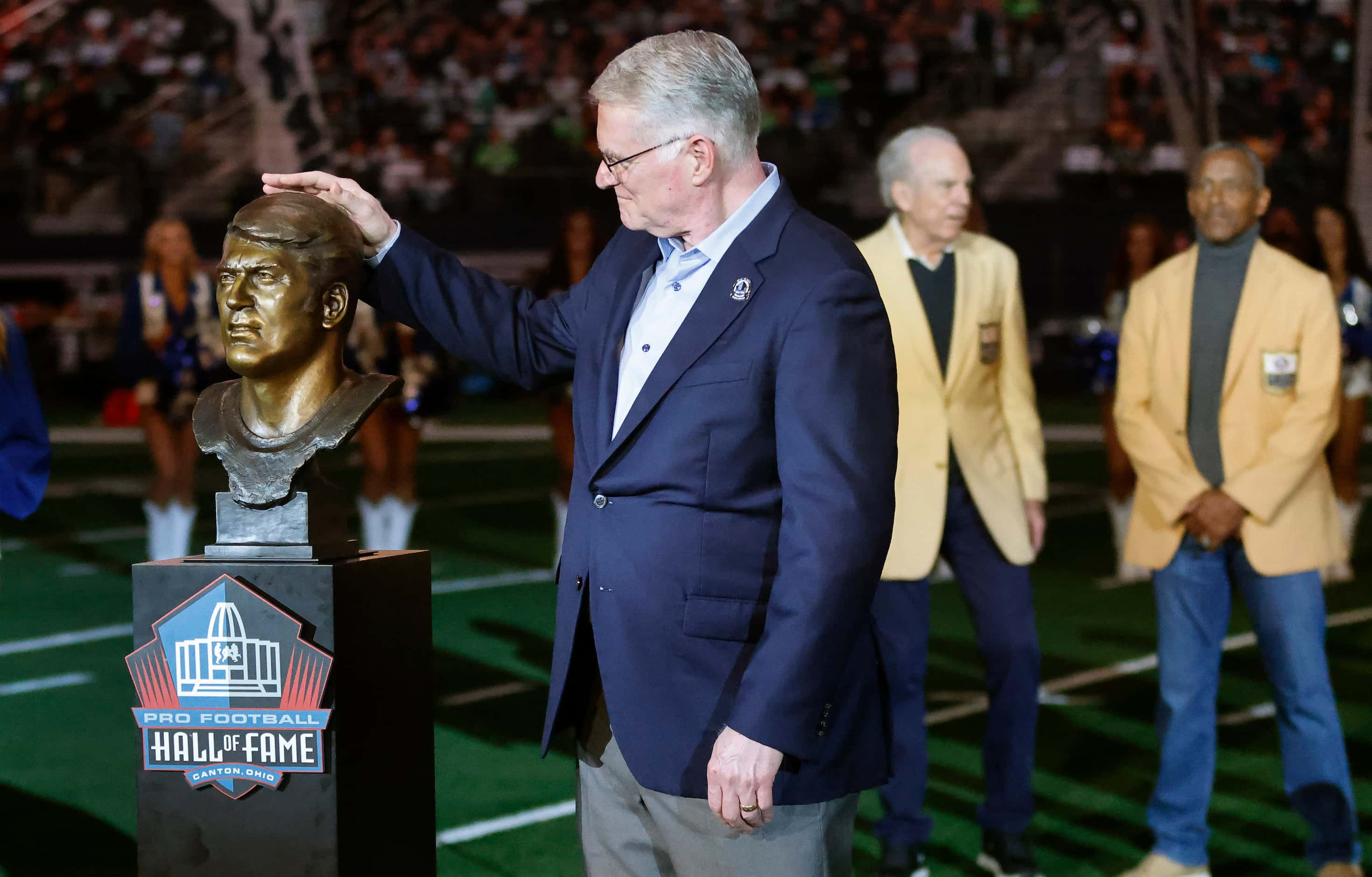 Scott Howley, son of Pro Football Hall of Famer Chuck Howley touches his father’s bust...