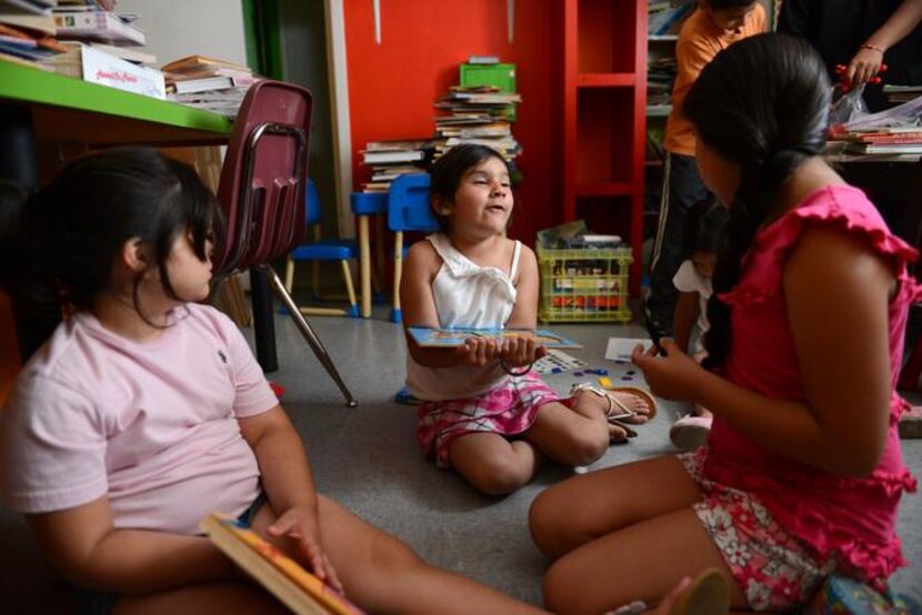 
Students (from left) Nayeli Revas, 7, Janeyz Guzman, 7, and Benita Espinosa play for the...