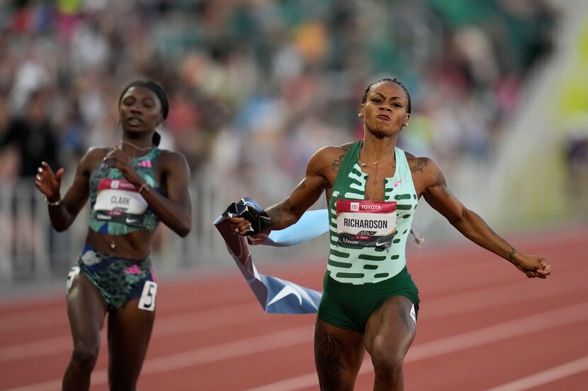 Sha'Carri Richardson grabs the tape as she wins the women's 100 meter finals ahead of Tamara...