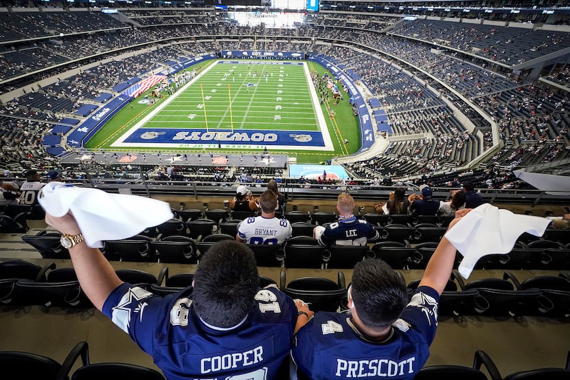 Dallas Cowboys fans Fernando (left) and Emmanuel Lopez of Abilene wave towels during the...