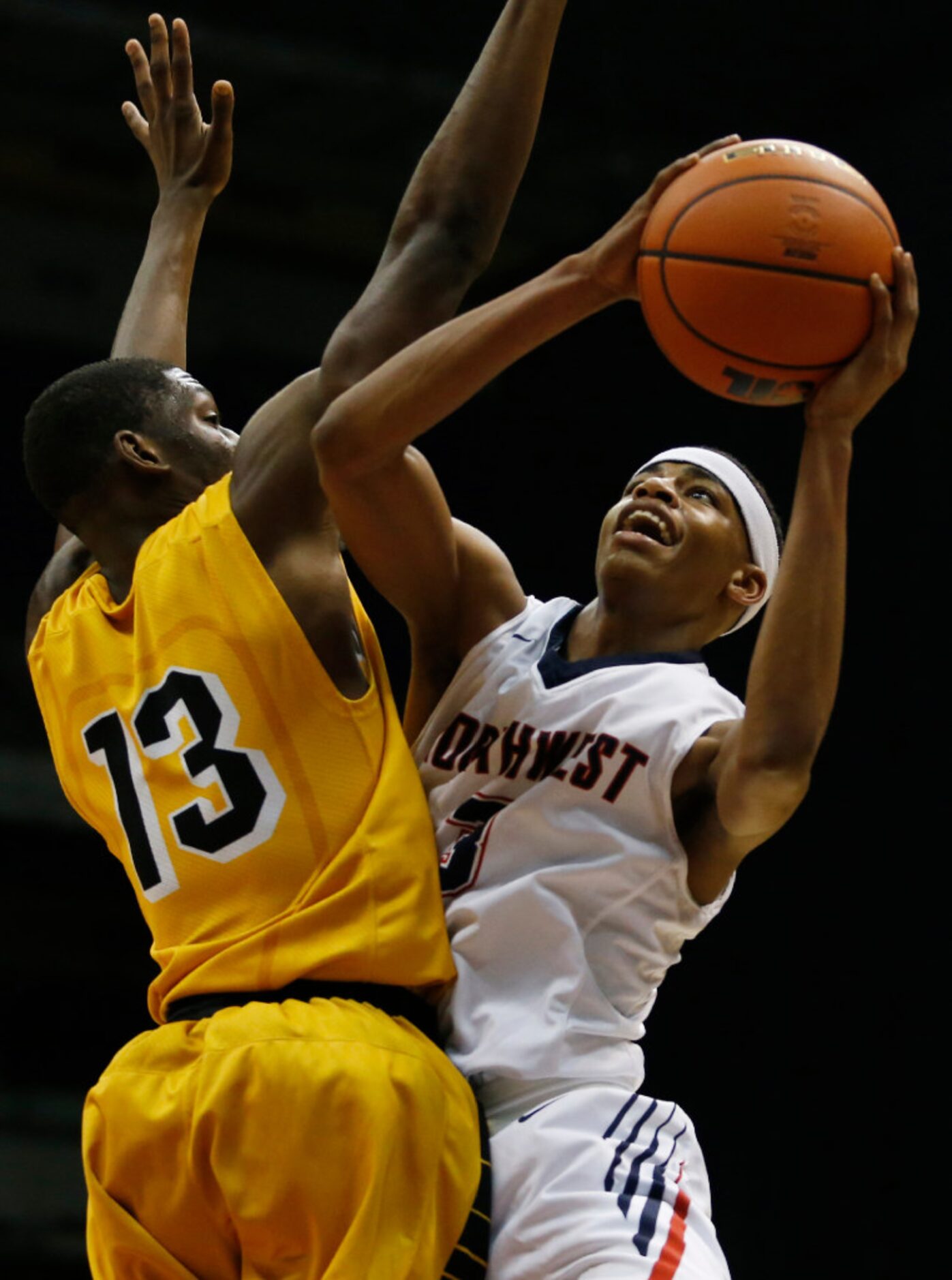 Justin Northwest's Avery Anderson (3) looks to score around Fort Bend Marshall's Dakota...