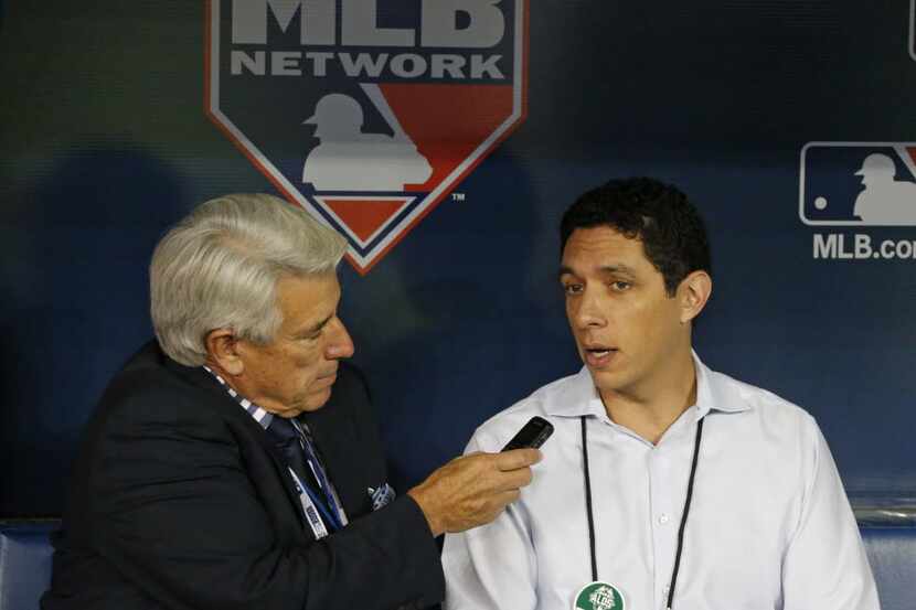 Texas general manager Jon Daniels, right, is interviewed by announcer Buck Martinez during...