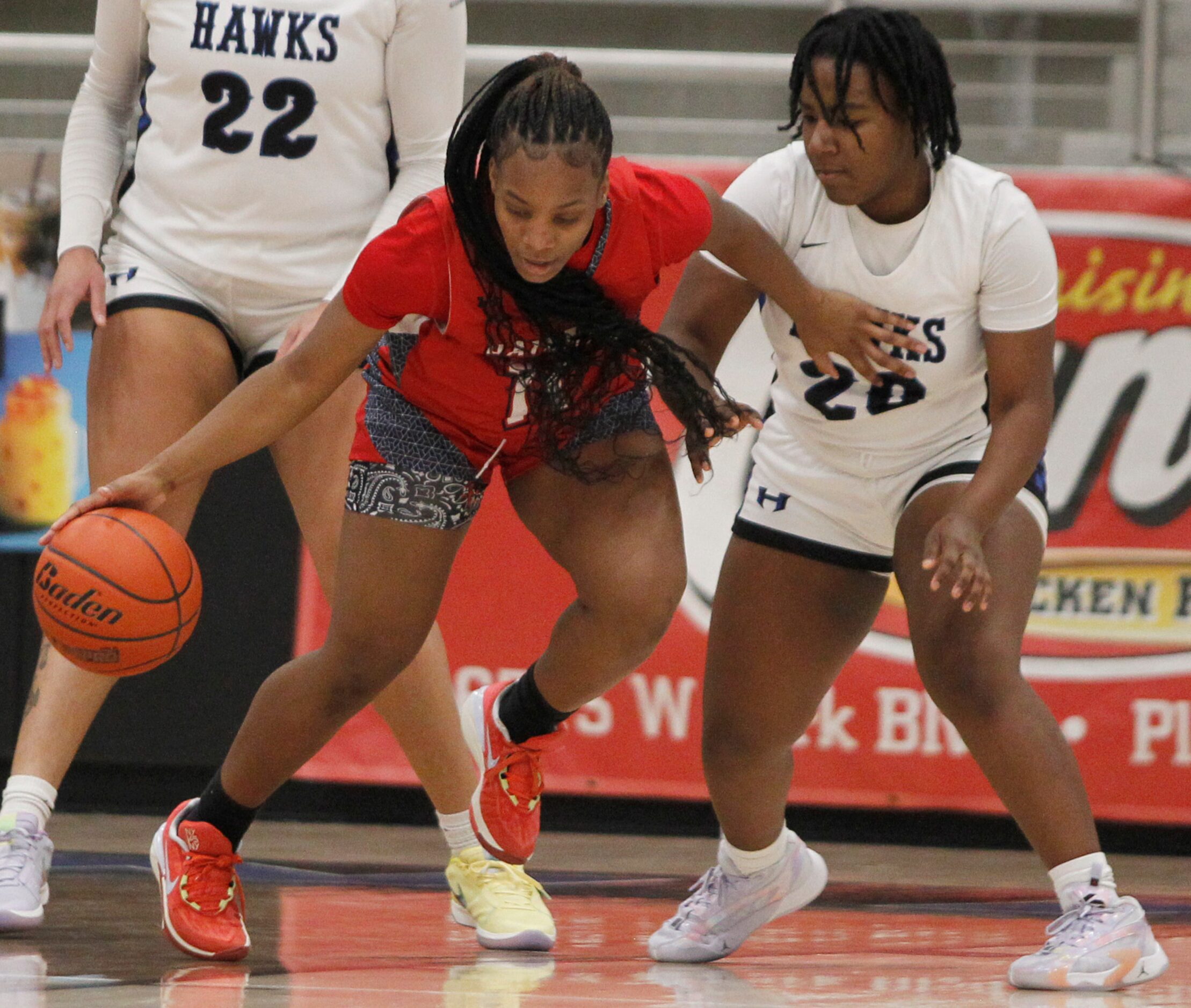 Denton Ryan forward A'Rosha Reed (11), left, dribbles against the defense of Hebron forward...