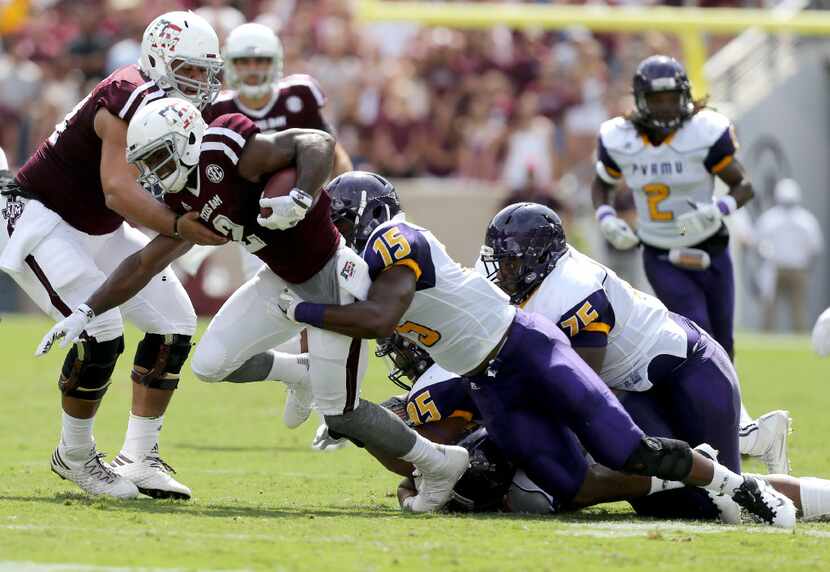 Texas A&M wide receiver Speedy Noil (2) is tackled by Prairie View A&M linebacker Jamespaul...