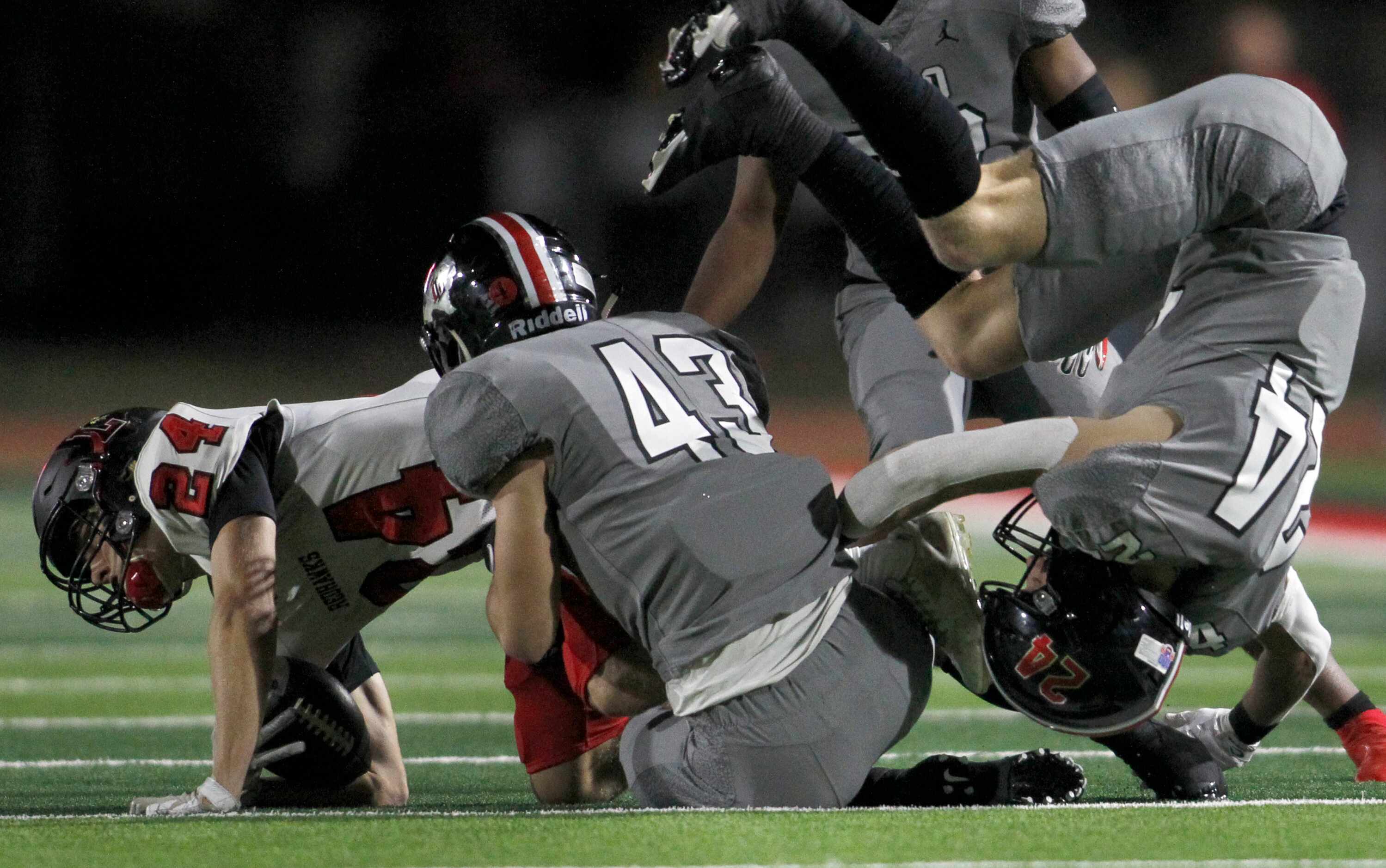 Frisco Liberty receiver Jack Bryan (24), left, is stopped at the defensive convergence of...